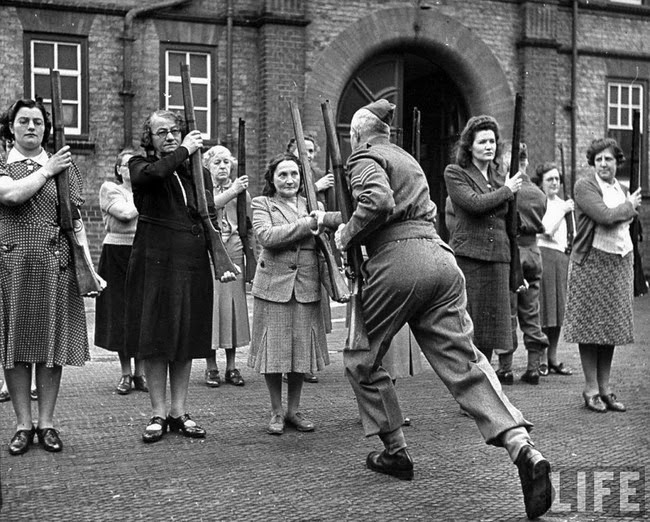 Middle aged women with guns being yelled at by an officer